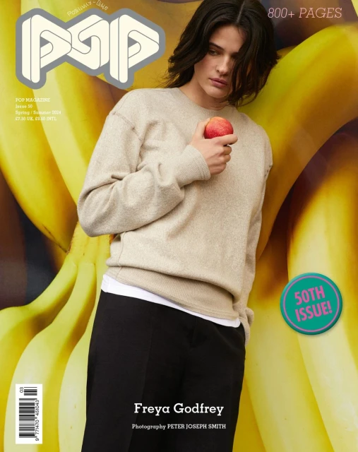 Magazine cover featuring a woman holding an apple in front of a banana background, promoting fashion and beauty.