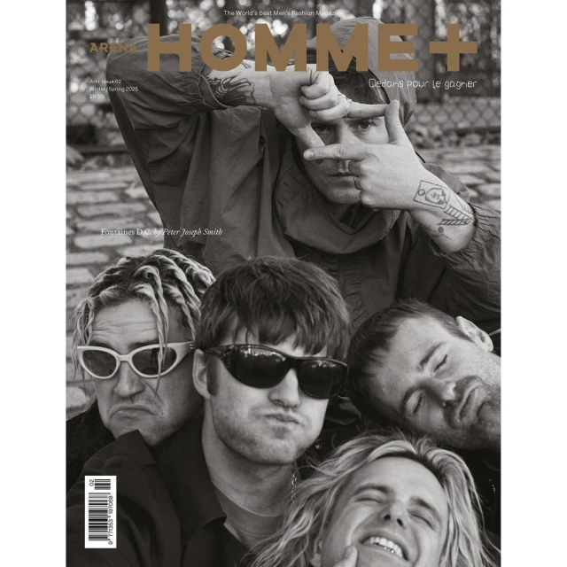 Black-and-white magazine cover featuring five men, with one framing his face with his hands and others clustered below.