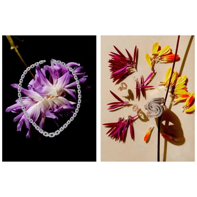 Product still life featuring a silver chain necklace with purple flowers and a silver ring and earrings with bright flower petals.