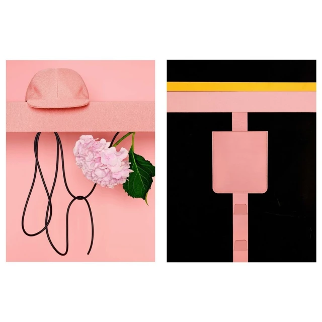Still life featuring a pink baseball cap, a pink hydrangea, and a black cord against a pink background alongside a pink design.