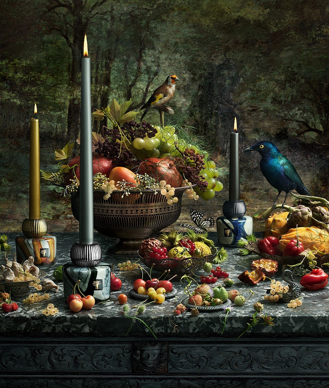 Still life image featuring candles, fruit, flowers, and birds arranged on a marble table against a dark, painterly background.