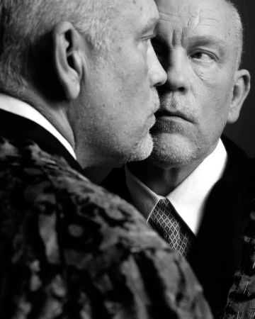 Close-up black and white portrait of John Malkovich reflecting in a mirror, captured by Peter Rigaud in Paris