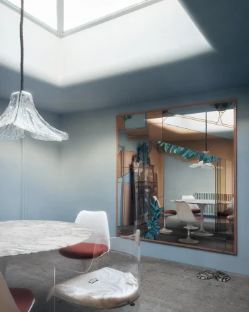 Interior with a round table and clear chairs, a decorative mirror reflecting another table and chairs, and a skylight overhead.