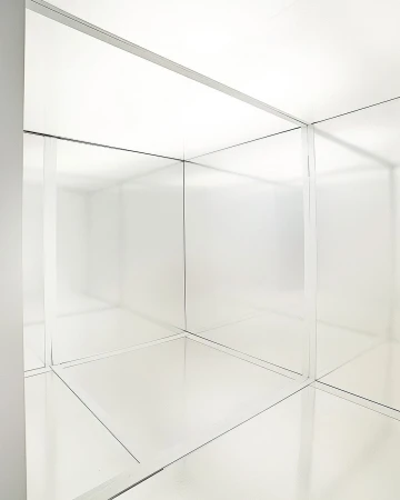 Abstract white room with mirrored surfaces and geometric lines creating a minimalist and architectural interior space.