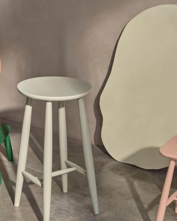 Three-legged stool in pastel light-blue color, modern minimalist design for home decor and furniture, against a neutral-toned background.