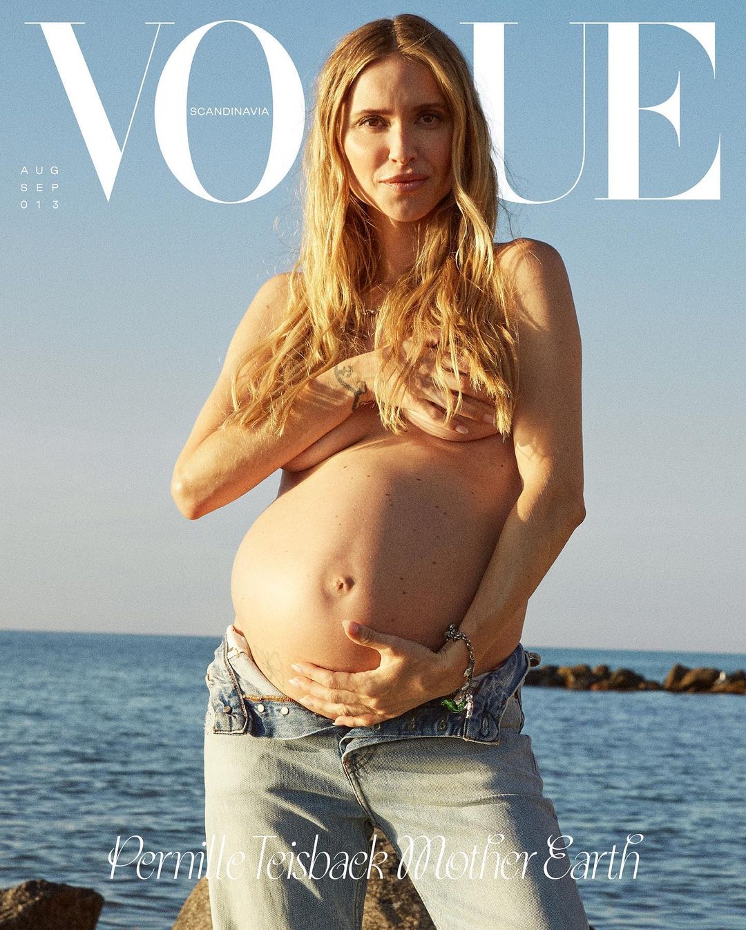 Vogue Scandinavia cover featuring a pregnant woman outdoors by the sea, wearing jeans and holding her chest. Text includes 'Permille Teisbaek'.