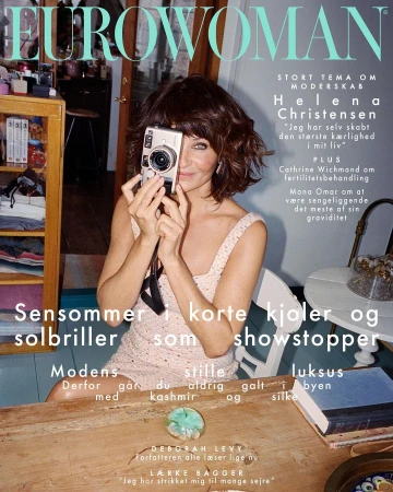 Helena Christensen holding a vintage camera in a domestic interior by photographer Petra Kleis for Eurowoman magazine cover.