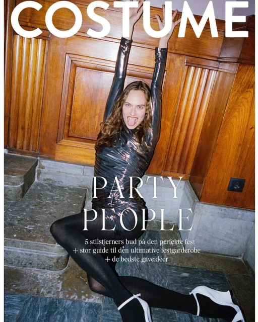 Magazine cover featuring a woman in a metallic dress posing on stairs, with the word 'COSTUME' displayed at the top of the image.