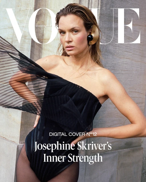 Vogue cover featuring Josephine Skriver in a black bodysuit and an art deco earring posing against a textured wall.