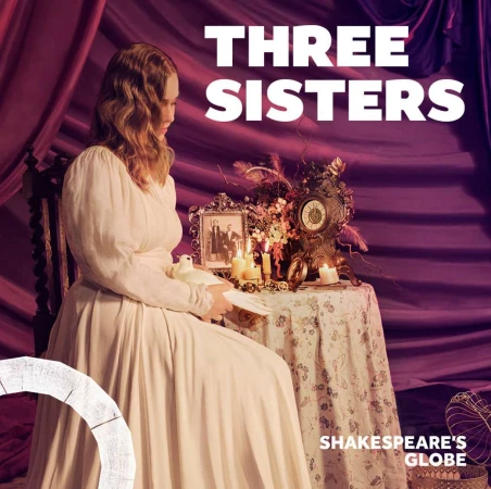 Woman in vintage dress holds a white dove with theatrical set with a clock, candles, family photograph, and a purple draped backdrop.