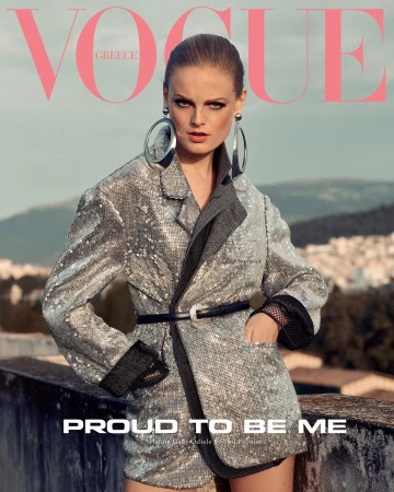 Vogue Greece cover featuring a stylish adult female model in a sequin blazer and shorts with oversized earrings, posing outdoors.