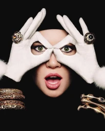 Close-up portrait of a woman making glasses shape over her eyes with white gloved hands and ornate gold jewellery.