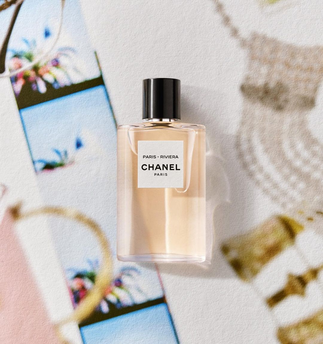 Chanel Paris-Riviera fragrance bottle on a patterned surface, showcasing minimalist design and luxury branding.