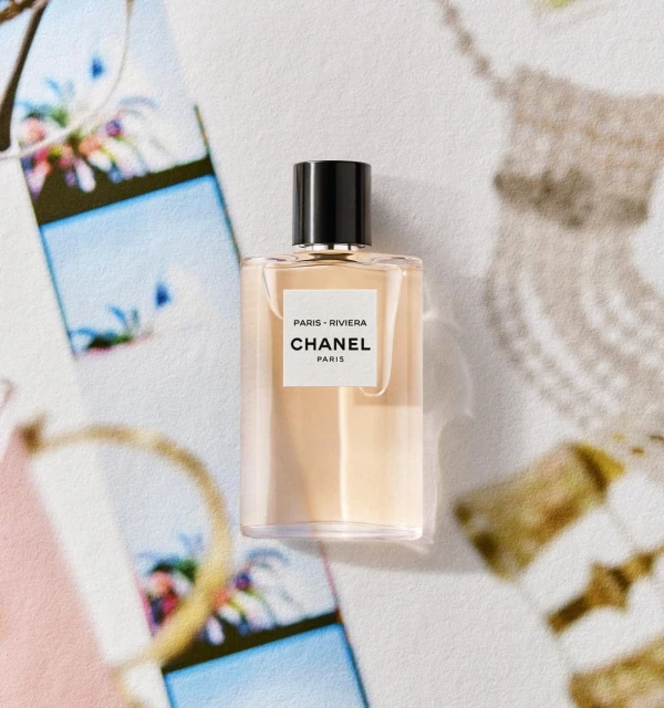 Chanel Paris-Riviera fragrance bottle on a patterned surface, showcasing minimalist design and luxury branding.