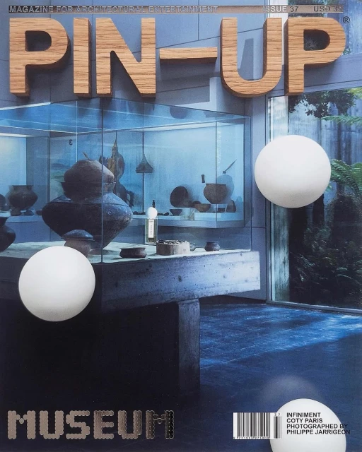 PIN-UP magazine cover featuring a museum display with pottery and two floating white spheres on a blue background.