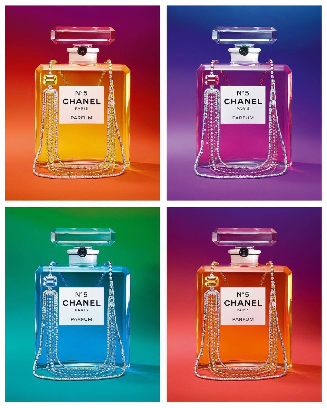 Four Chanel N°5 Parfum bottles in a grid, each filled with a different-colored liquid: yellow, magenta, blue, and orange. Perfume concept.