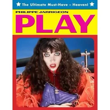 Brunette woman in red with a handbag in front of a red and blue background with “PLAY” and other text above her.
