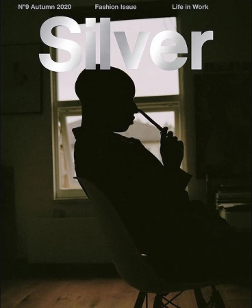 Silhouette of a person seated on a chair in front of a window, with the word Silver printed across the top.