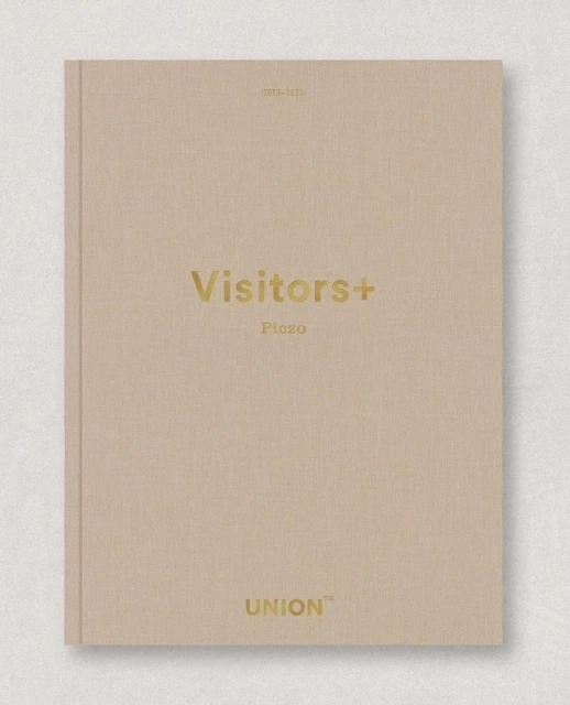 Tan hardcover book cover with 'Visitors+' and 'Union' printed in gold text. Clean studio shot on a neutral surface.