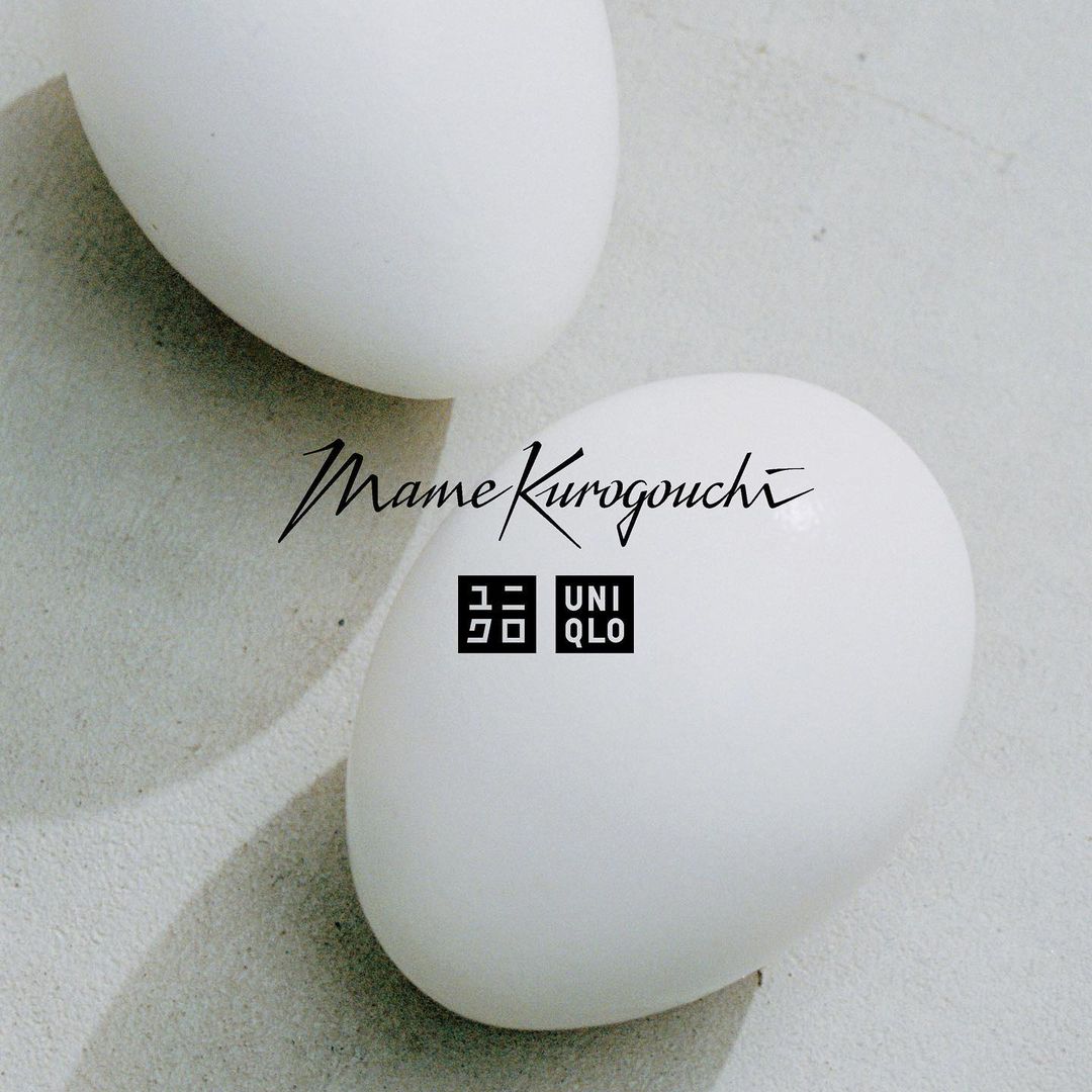 Two white eggs are shown up close with text overlay 'Mame Kurogouchi' and the Uniqlo logo. The eggs are softly lit, and smooth.