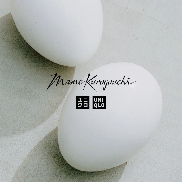 Two white eggs are shown up close with text overlay 'Mame Kurogouchi' and the Uniqlo logo. The eggs are softly lit, and smooth.