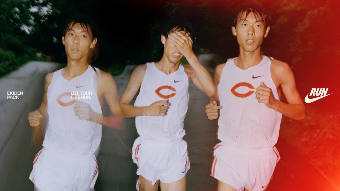 Three male athletes in matching Nike running gear are captured mid-stride on an outdoor course. One runner covers his eyes during a race.