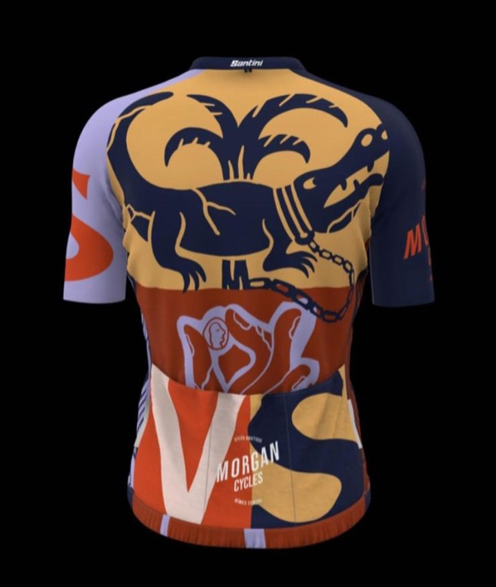 Graphic cycling jersey featuring a stylized alligator, palm trees, and human figures in shades of orange, blue, and gold on black background.