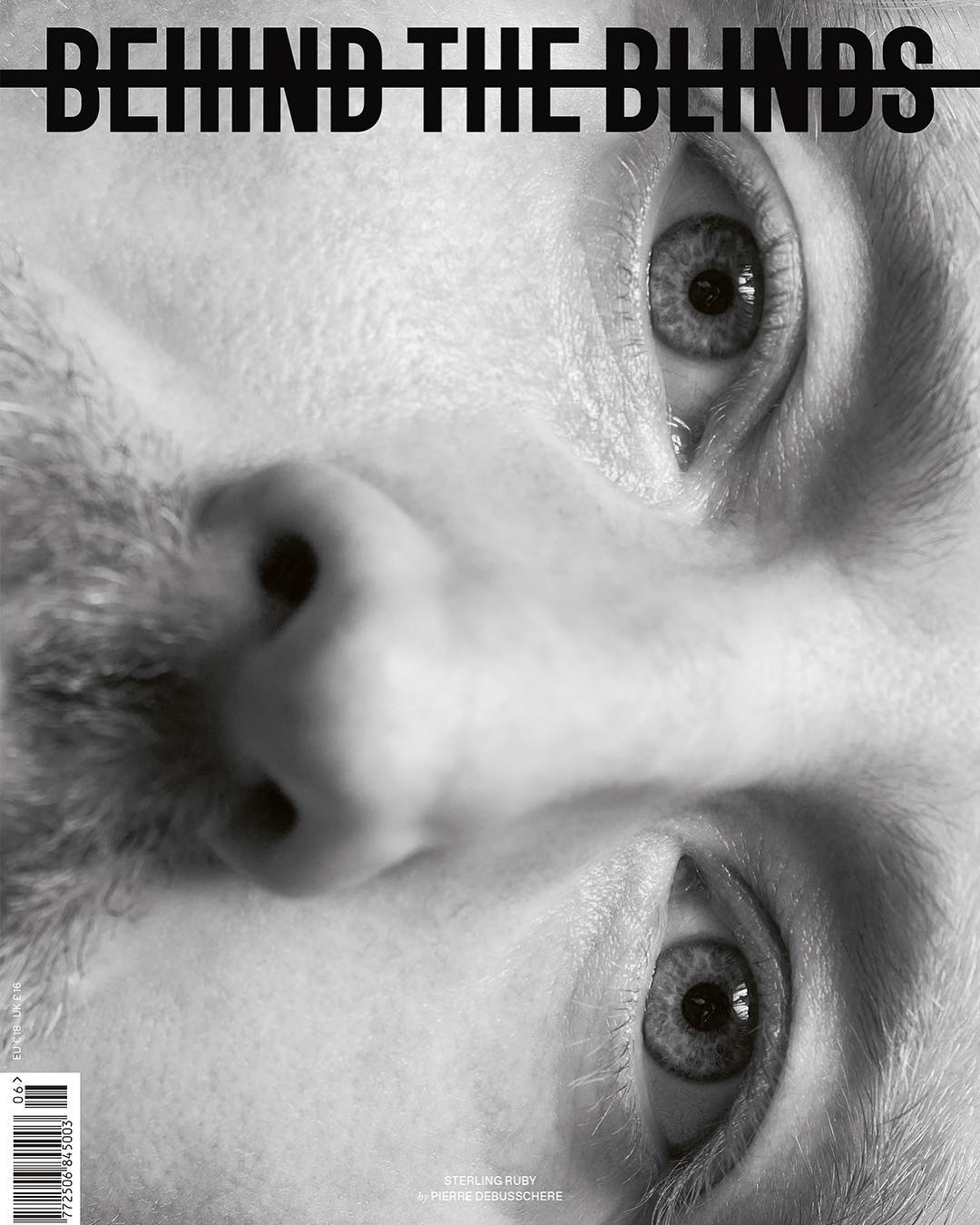 Black and white close-up of a man's face, presented upside down, with a magazine title 'Behind the Blinds' overlaid.