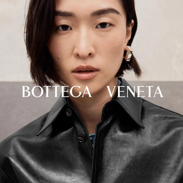 Close-up of a young Asian woman wearing silver geometric earrings and a black leather jacket, with the Bottega Veneta logo overlaid.