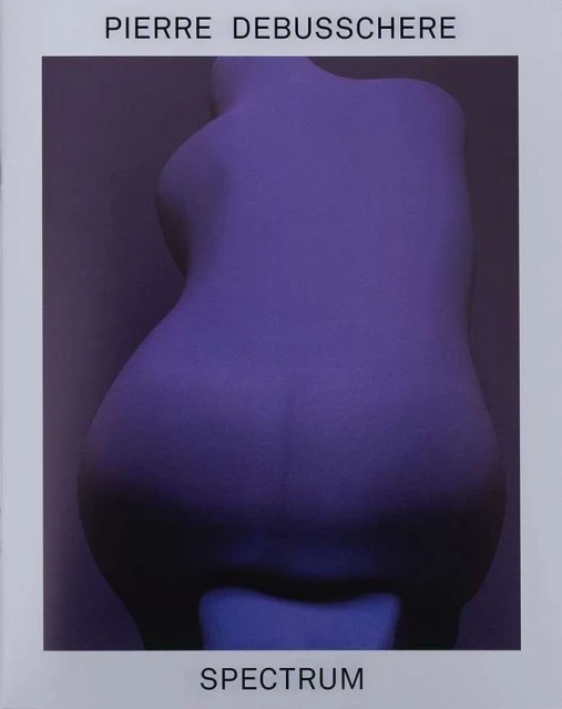 Back view of a female torso sculpture in a purple light against a purple background. Title text 'Spectrum' and artist name.