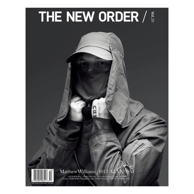 Monochrome portrait of adult male on a magazine cover wearing a cap and face covering, with overlaid typography and text elements.