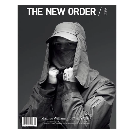 Monochrome portrait of adult male on a magazine cover wearing a cap and face covering, with overlaid typography and text elements.