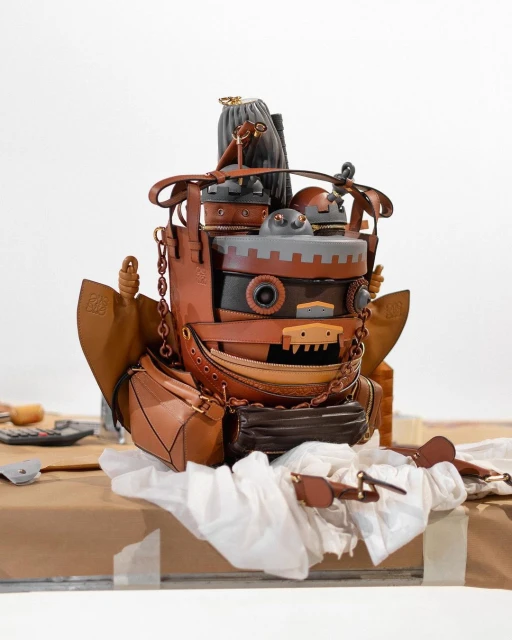 A whimsical, steampunk-inspired handbag crafted from leather, showcasing a layered, sculptural design with various compartments and unique details.