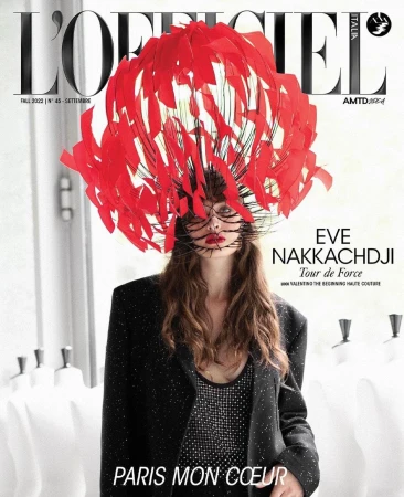 L'Officiel Italia magazine cover featuring a stylish adult female model in a black blazer and a red feathered headpiece.
