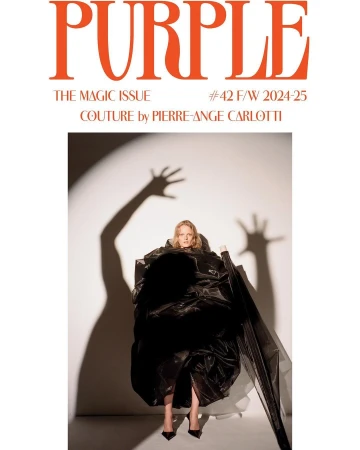 Blonde woman in a voluminous black dress poses for the cover of Purple Magazine's Magic Issue against a white backdrop with shadow art.