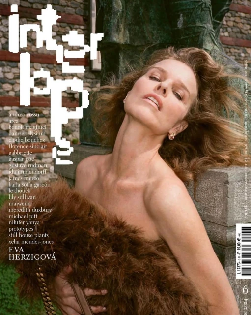 Magazine cover featuring a woman with curly hair, draped in a brown fur stole, posing against a stone background outdoors.