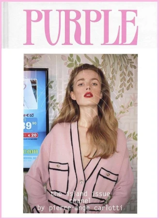 Magazine cover featuring a young woman with red lipstick, wearing a pink cardigan, with a television and floral wallpaper in the background.