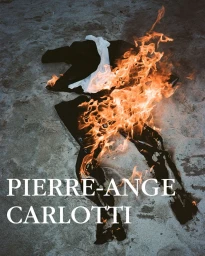 Burning clothes on a sandy beach at night photographed by Pierre-Ange Carlotti
