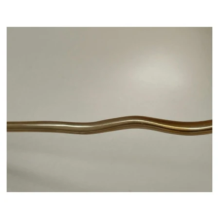 Abstract studio shot of a curved brass tube against an off-white background, with a simple, modern aesthetic, and soft lighting.
