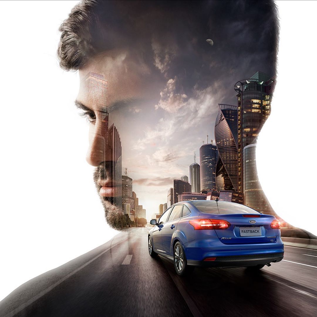 Automotive advertisement features a double exposure of a man's face and profile over an image of a blue Ford on a city road.