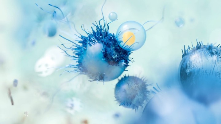Computer-generated image of blue, green, and white spherical shapes with fine, thread-like projections and bubble-like orbs, macro view.