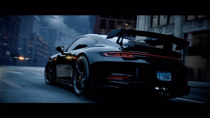 Sleek black Porsche 911 GT3 speeds through a nighttime urban environment, rain-slicked streets reflecting city lights.