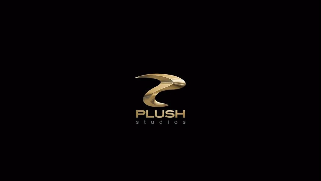 Elegant 'Plush Studios' logo featuring a stylized gold emblem on a black backdrop, conveying sophistication and brand identity.