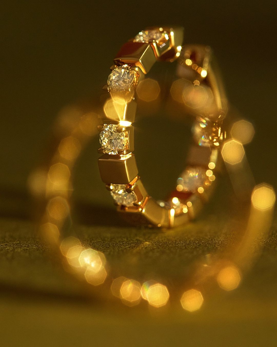 Close-up of a gold ring with diamond accents, showcasing a warm color palette and shallow depth of field.