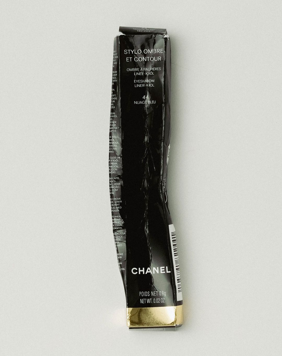Wrinkled black Chanel Stylo Ombre et Contour eyeliner box. The packaging is black with white text and a gold band at the bottom.