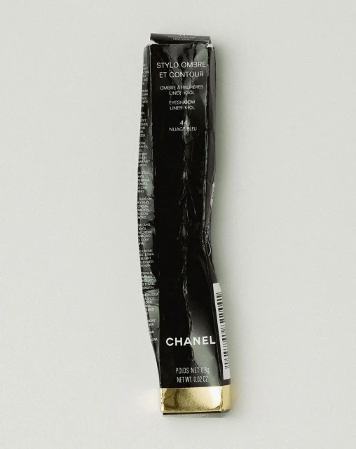 Wrinkled black Chanel Stylo Ombre et Contour eyeliner box. The packaging is black with white text and a gold band at the bottom.