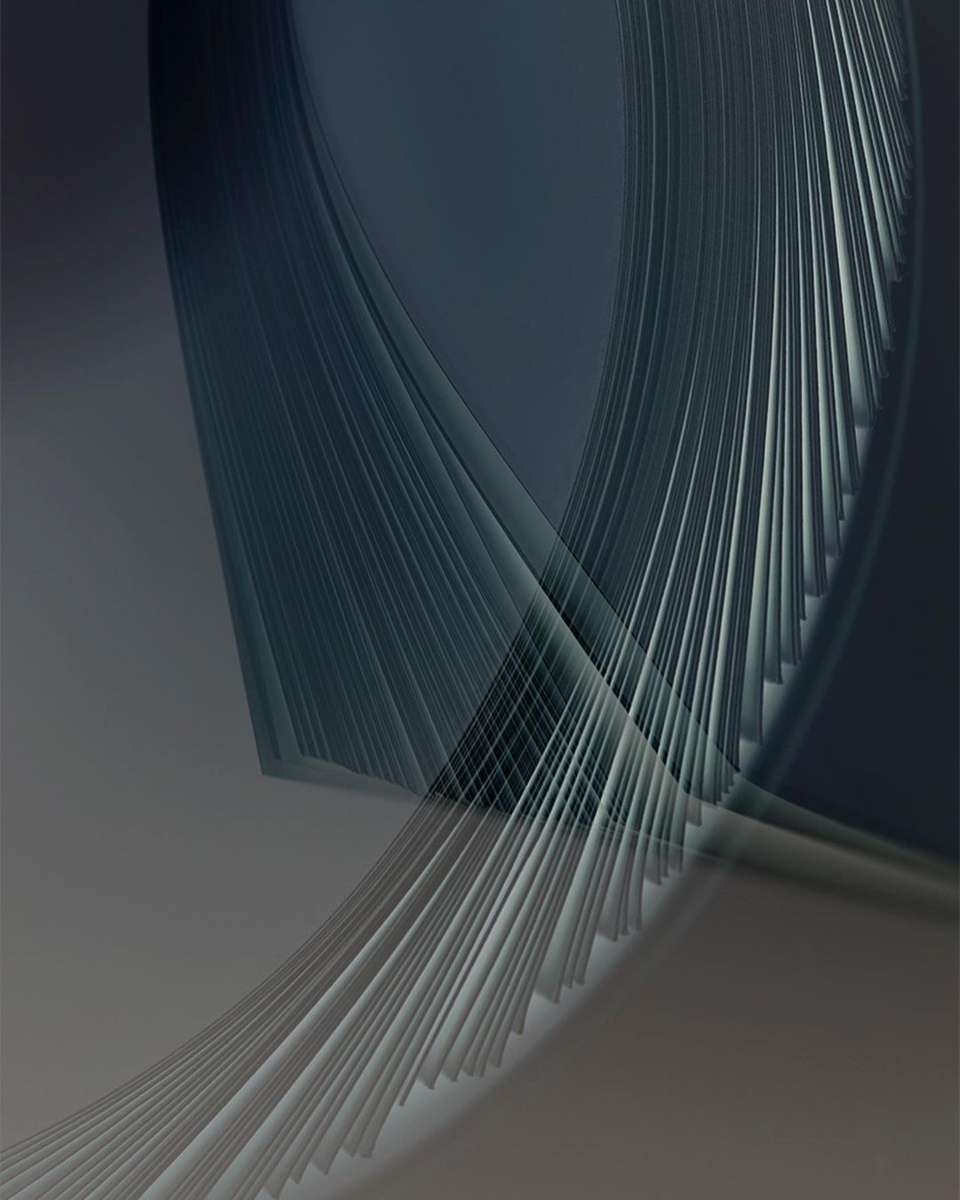Abstract image featuring curved lines and gradient shades of gray and blue, creating a modern and artistic composition.