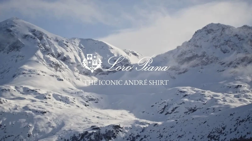 Snow-covered mountain range landscape with Loro Piana branding and text overlay