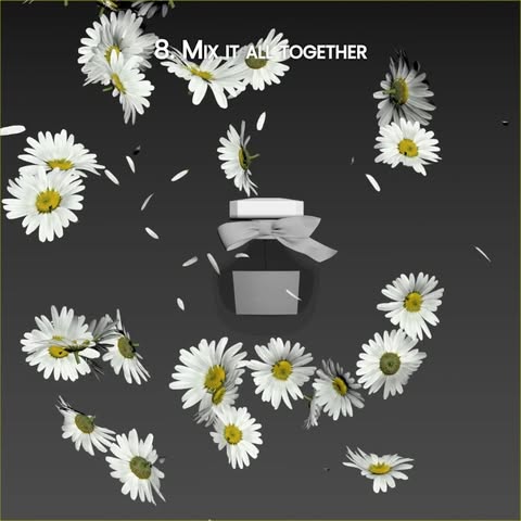 Conceptual shot of a clear perfume bottle surrounded by white daisy flowers and petals against a neutral gray gradient background.
