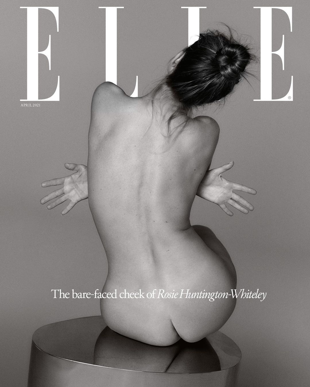 Elle Magazine cover featuring a nude woman sitting on a round metallic surface, back to camera, arms outstretched, against a grey backdrop.